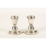 A pair of Queen Elizabeth II sterling silver dwarf candlesticks, hallmarked for Birmingham 1977,