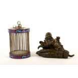 A Chinese cloisonne enamel white metal cricket cage and a parcel-gilt bronze Buddhist figure, the