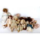 A collection of various German dolls, mostly 19th Century, with bisque heads and some spare parts,