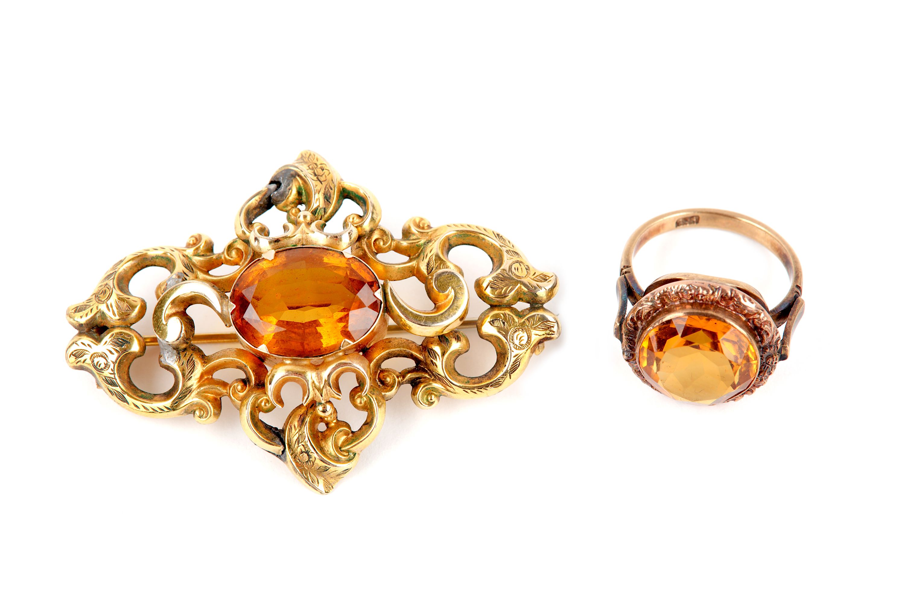 A late 19th century citrine brooch, and an early 20th century citrine ring, brooch with evidence