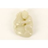 A Chinese jade carving of a boy, seated clutching an oversized double gourd, 4.8cm high