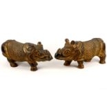 A pair of Indian carved wood parcel gilt models of standing Rhinoceros, 56cm long (2)