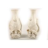 A pair of blanc de chine porcelain vases, 20th Century, decorated with dragons chasing flaming