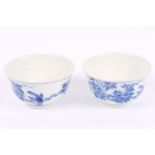 A pair of Chinese blue and white tea bowls, decorated with flowers and birds, 7.7cm diameter (2)
