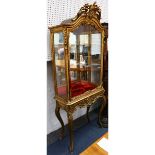 A giltwood display cabinet in Louis XV style, late 19th Century, with single glazed door, raised