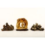 Three Chinese carved soapstone groups, two in the shape of mountain peaks each carved with a luohan,