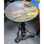 A Victorian papier mache occasional table, the circular tilt top painted with a view of the