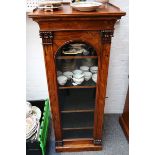 A tall Victorian rosewood pier cabinet, with upper gallery over arched glazed door, on plinth