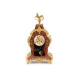 A Boulework mantle clock, with gilt embellishments in Rococo style, surmounted by gilt flagon