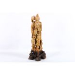 An Oriental soapstone carving of a provincial fisherman, early 20th Century, wearing a long robe,