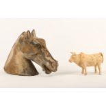 A Chinese pottery model of a horse head and an ox, Tang dynasty, the horse looking straight ahead