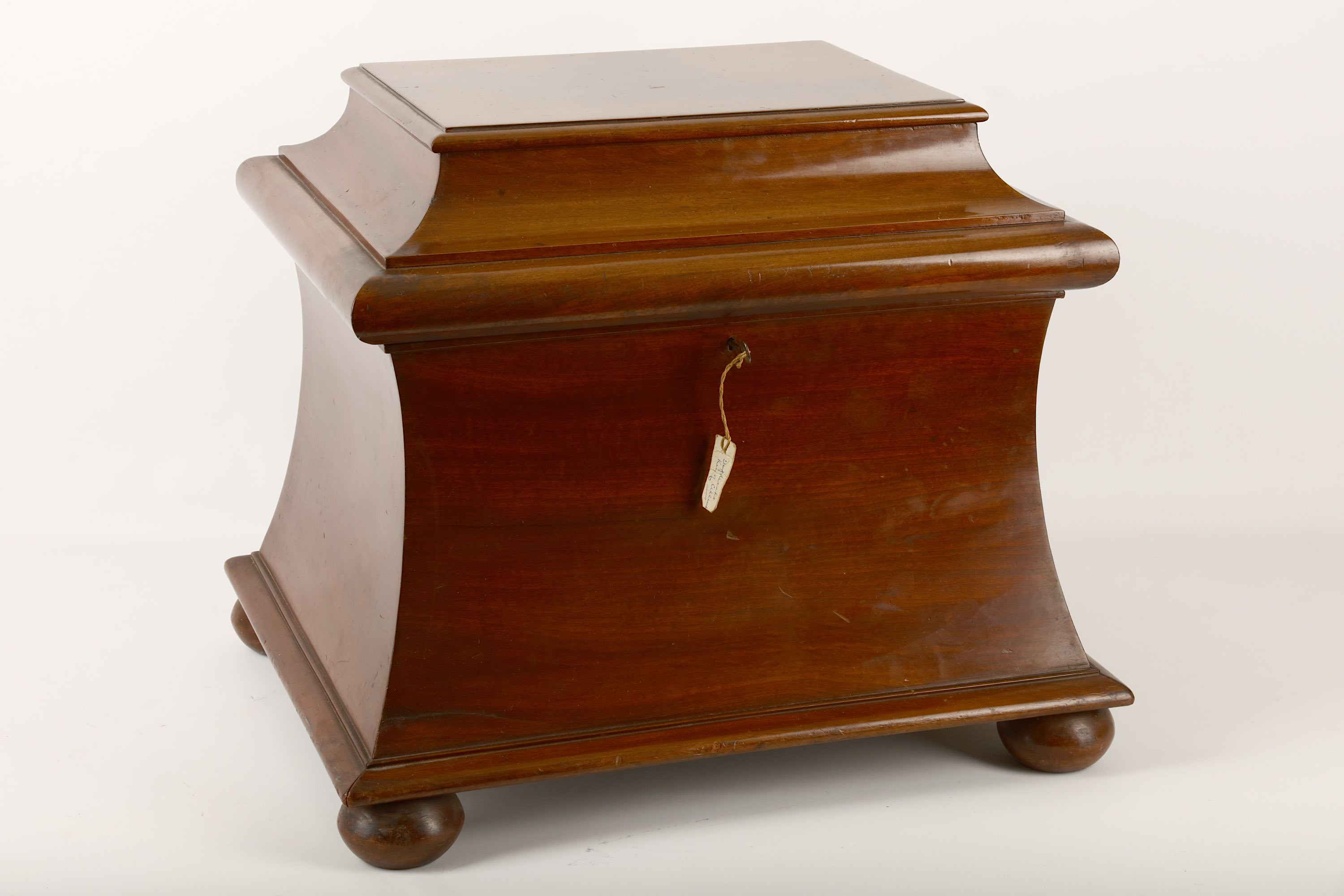 A Victorian mahogany cellarette, of rectangular sarcophagus form, the hinged top enclosing a