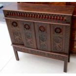 A small Breton carved oak side cabinet, 19th Century, with spindle frieze and pierced chip carved