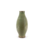 A Chinese long quan celadon vase, Ming dynasty or later, the body rising from a flared foot up to