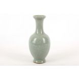 A Chinese celadon glazed vase, the extended globular body rising to a trumpet neck from a flared
