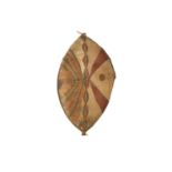 A ZULU SHIELD A large leaf shaped shield, composed of animal hide stretched over a wood frame,