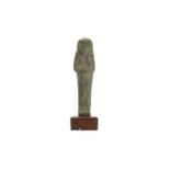 A GLAZED COMPOSITION SHABTI New Kingdom - Late Period, circa 1550 - 30 B.C. Depicting in typical