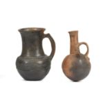 TWO TRIBAL VESSELS Two burnished pottery jugs, one