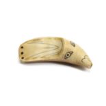 A MAORI WHALE TOOTH AMULET The curved tooth tapers to a point, with three pierced holes for