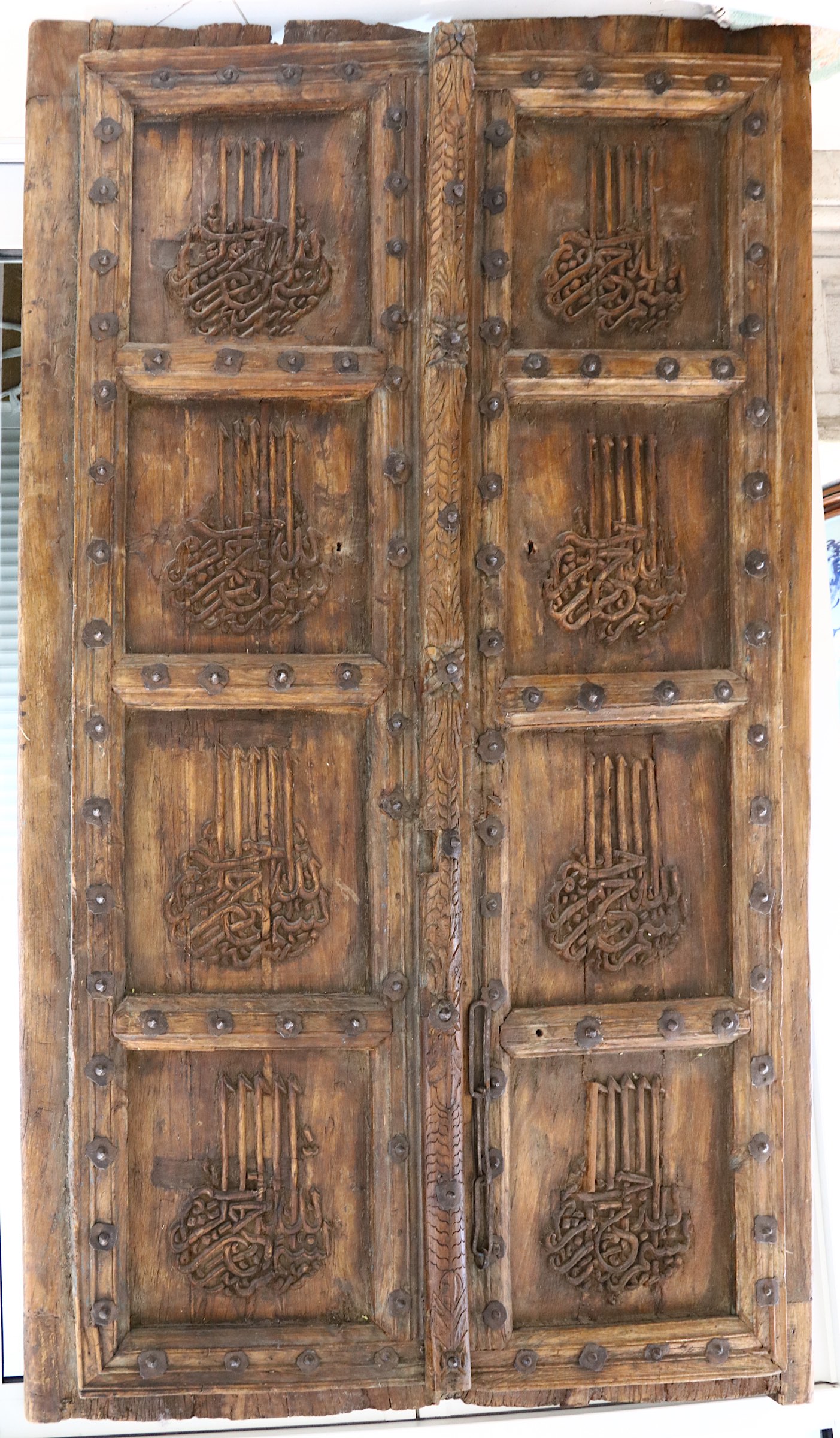 A monumental pair of carved Islamic doors with surrounding portal, 18th or 19th Century, both carved