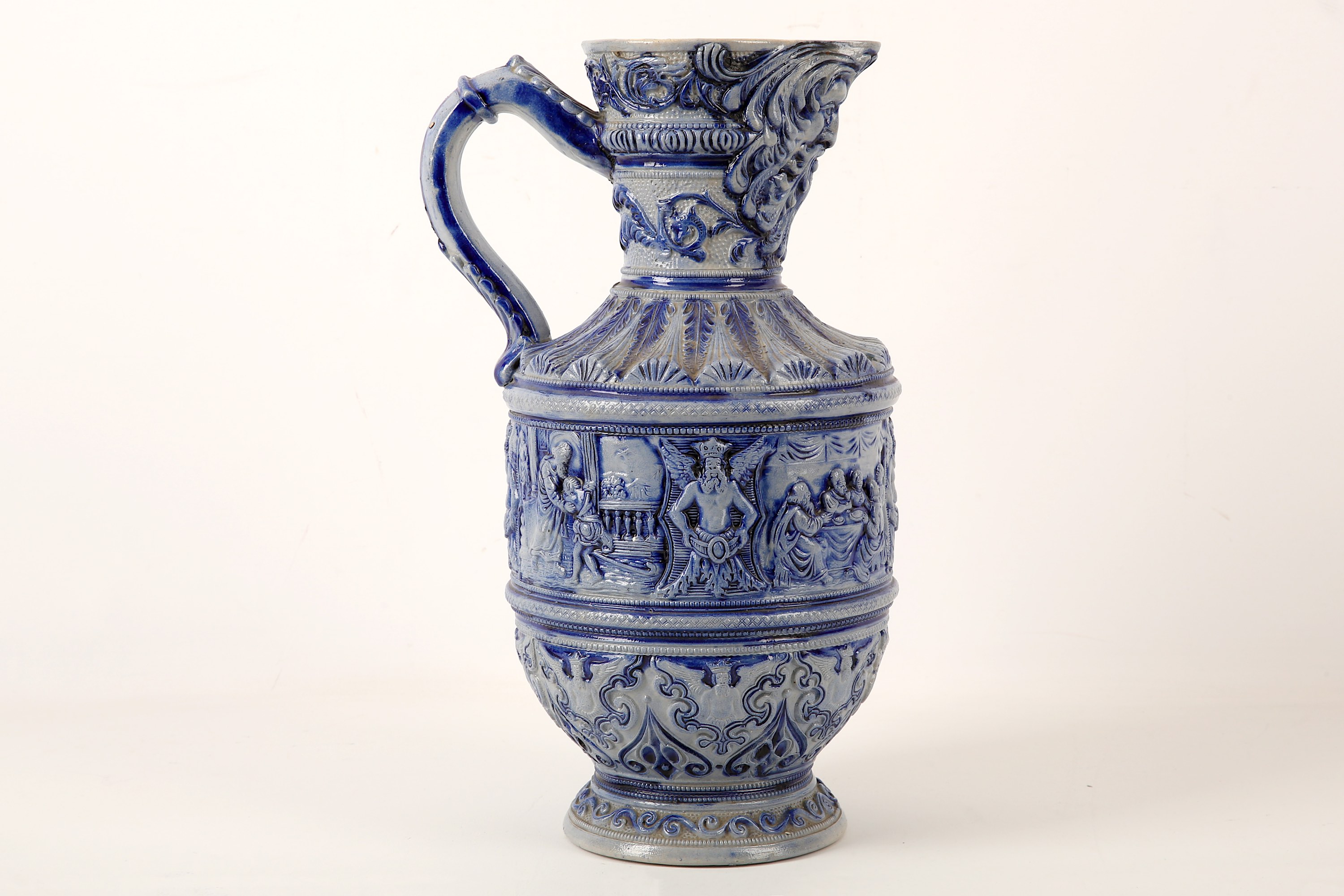 A German Westerwald salt-glazed stoneware ewer, early 20th Century, moulded with ecclesiastical - Image 2 of 2