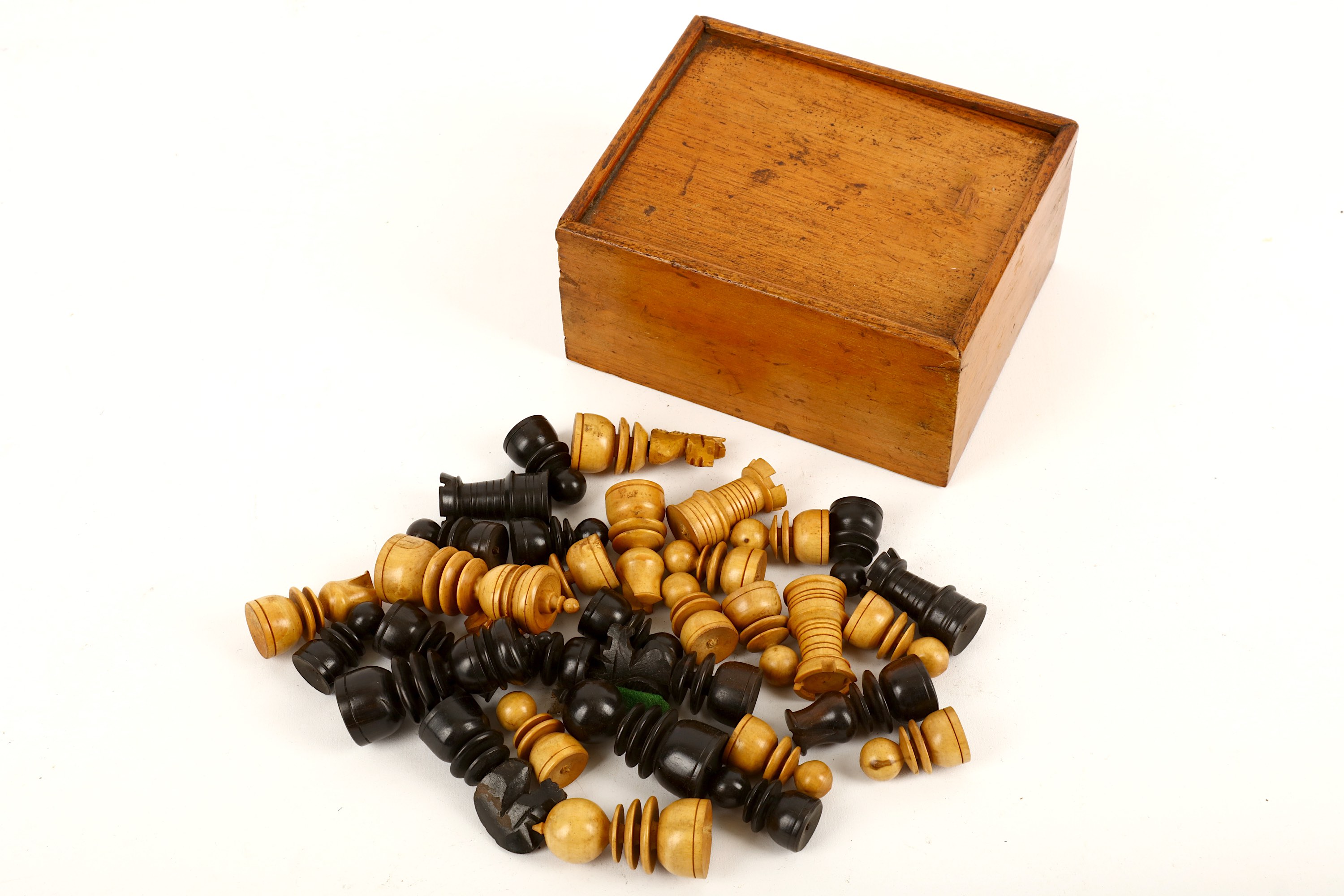 A late Victorian or early Edwardian boxwood and stained ebony chess set, of tapering form,