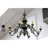 A French wrought iron chandelier, mid-20th Century, with gilded detail, in the manner of Jean
