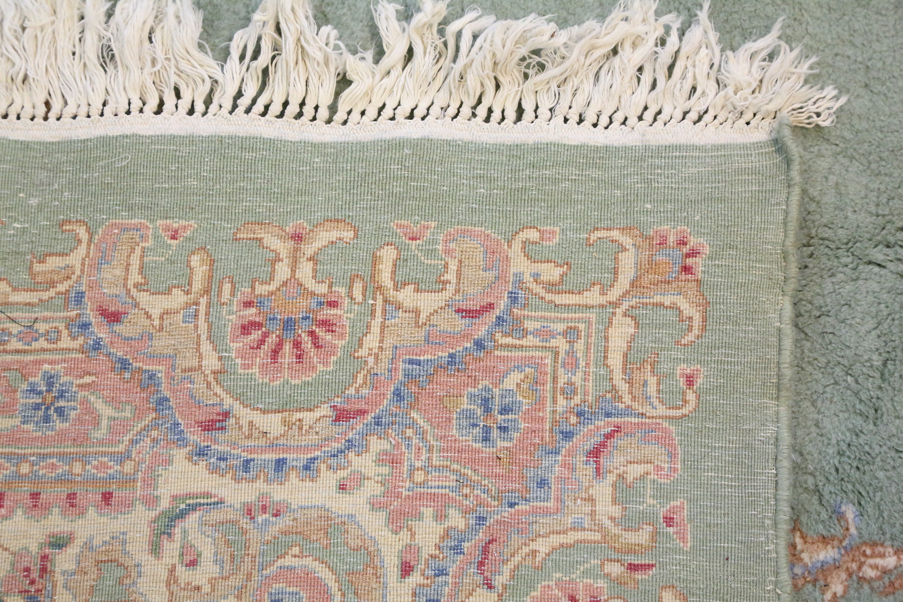 A fine Kirman carpet, South Persia, the soft green field with central floral medallion, linked - Image 3 of 4