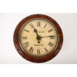 A late Victorian oak-cased wall clock, with a carved foliate border, the white enamel dial with