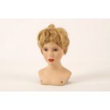 A Continental bisque beauty shop display bust, mid-20th Century, modelled as a young girl, set