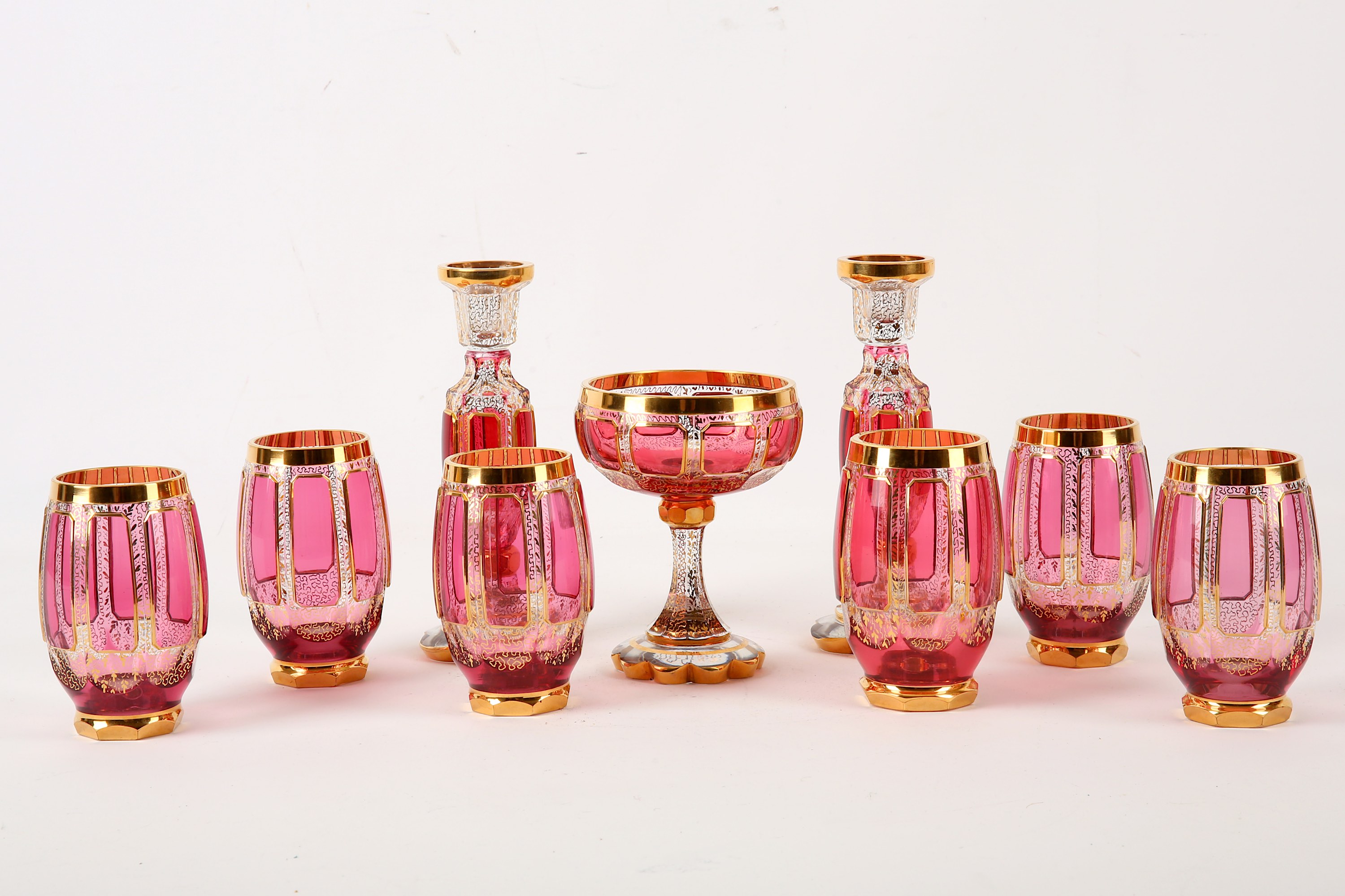 A set of Bohemian clear and cranberry stained glasses, late 19th / 20th Century, with gilt