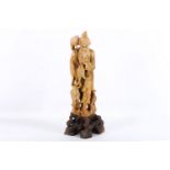 An oriental soapstone carving of a provincial fisherman, early 20th Century, wearing a long robe,