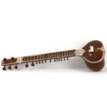 A wooden ivory-inlaid sitar, India, 20th Century, of traditional form, with 17 strings, with gourd-