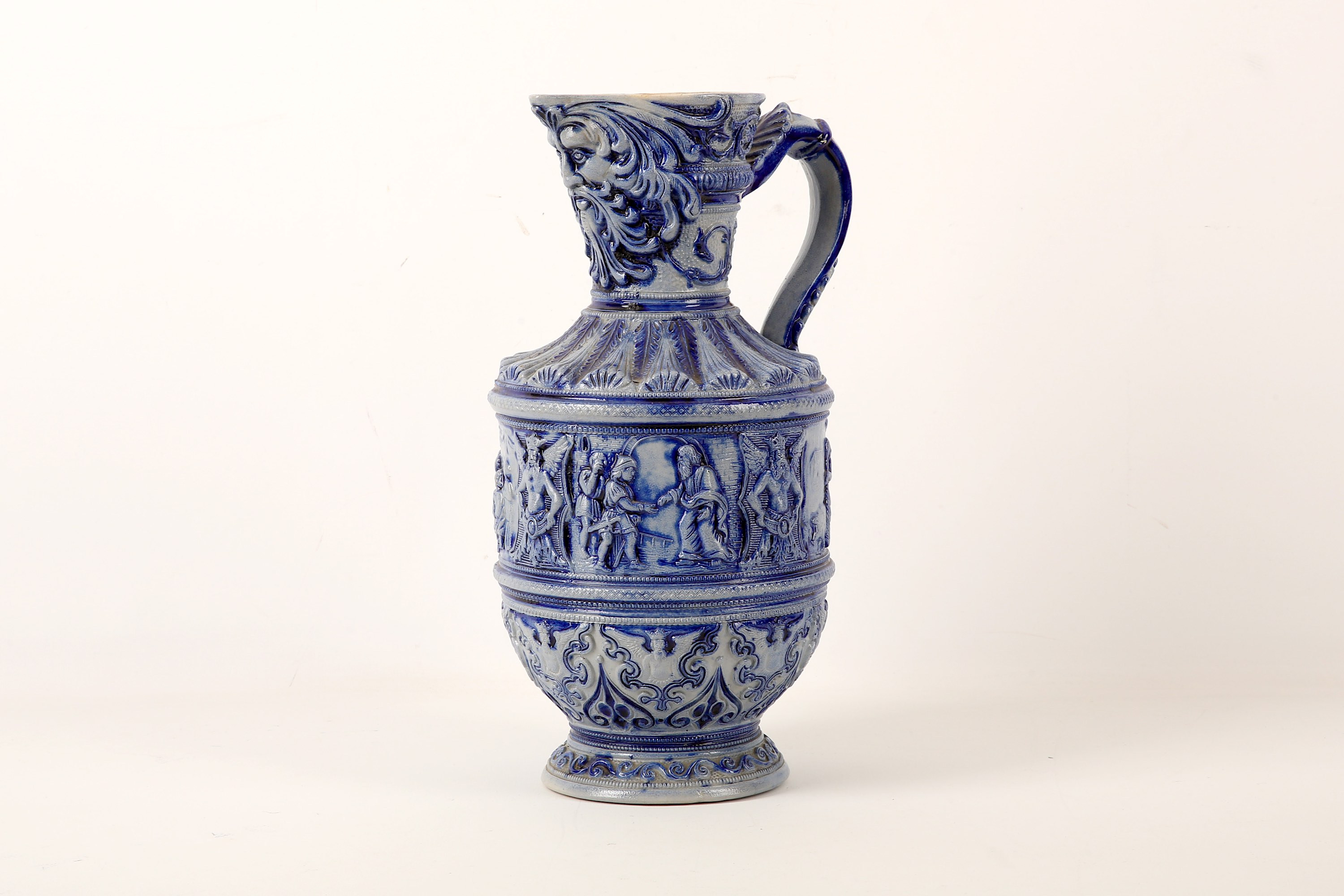 A German Westerwald salt-glazed stoneware ewer, early 20th Century, moulded with ecclesiastical