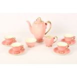 A Royal Winton porcelain tea service for four, early 20th Century, in 'Petunia' pattern on pink