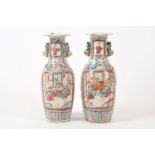 A pair of Cantonese baluster vases, 19th Century, in famille rose design and palette, decorated with