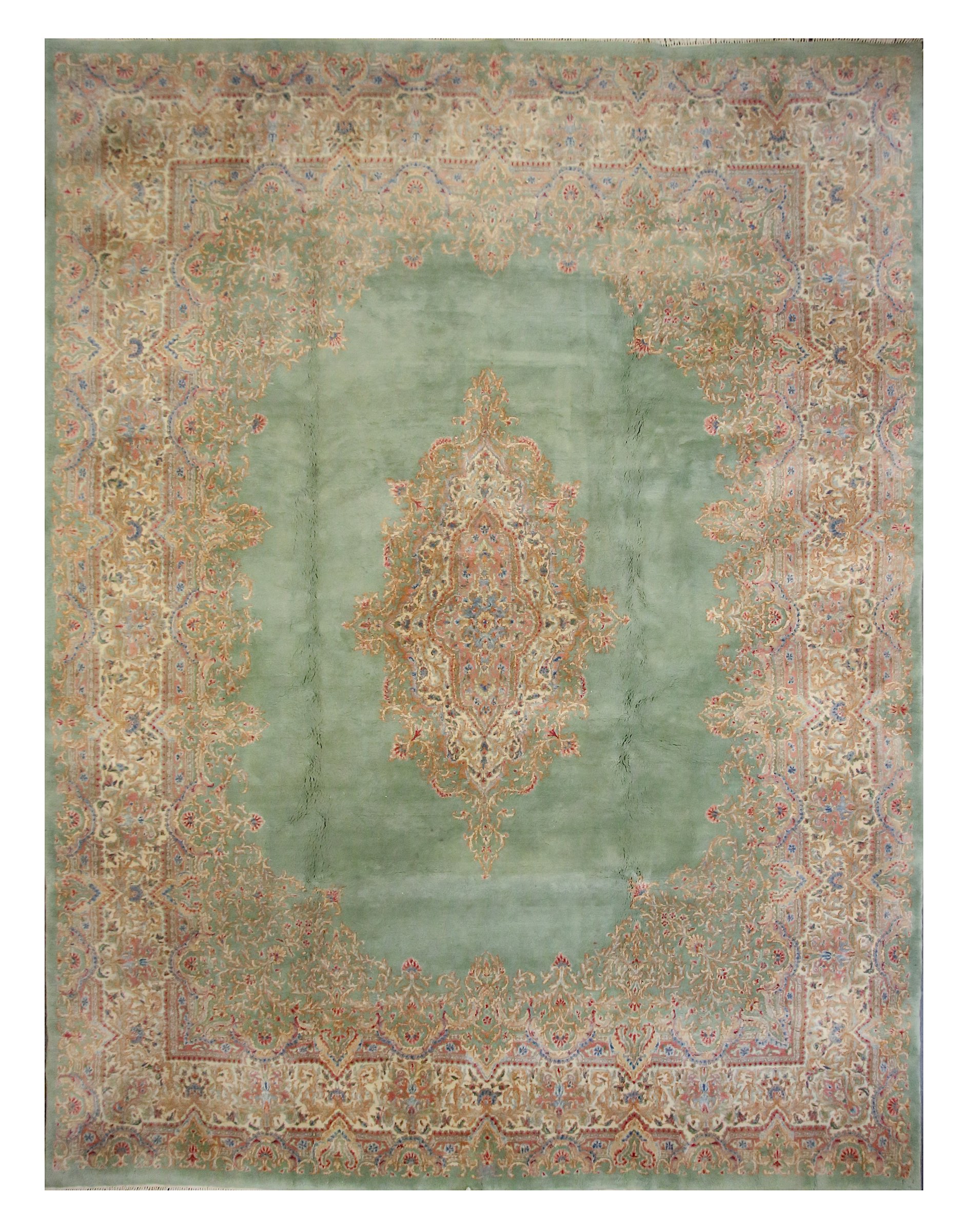 A fine Kirman carpet, South Persia, the soft green field with central floral medallion, linked