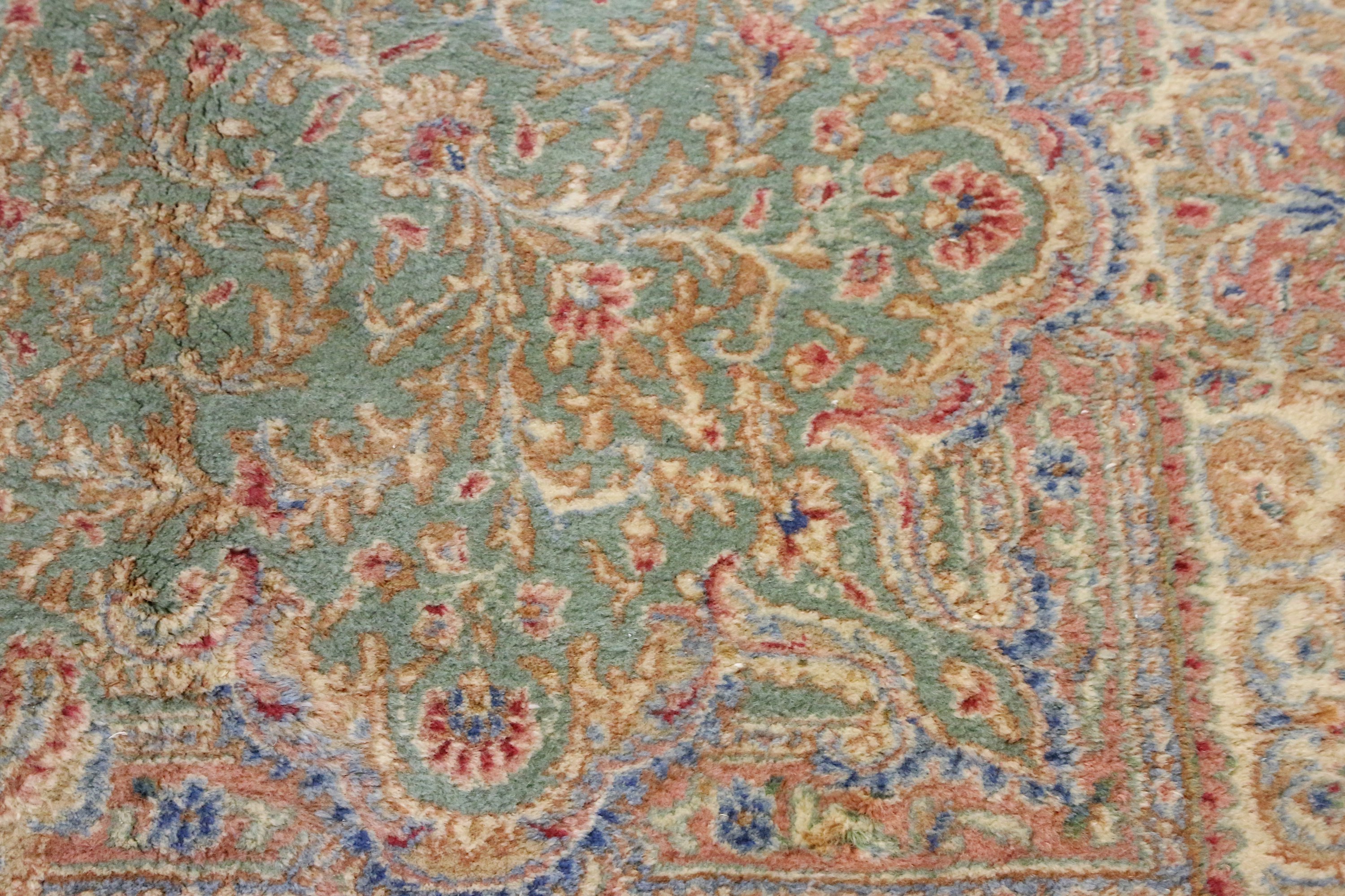 A fine Kirman carpet, South Persia, the soft green field with central floral medallion, linked - Image 4 of 4