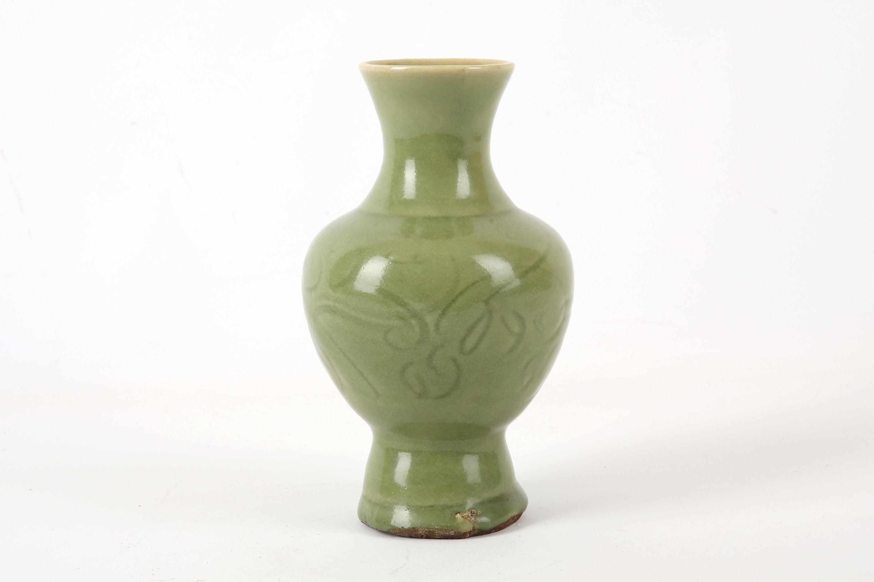 A Chinese celadon glazed vase, Ming Dynasty, of baluster form with an everted rim, decorated with