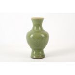 A Chinese celadon glazed vase, Ming Dynasty, of baluster form with an everted rim, decorated with