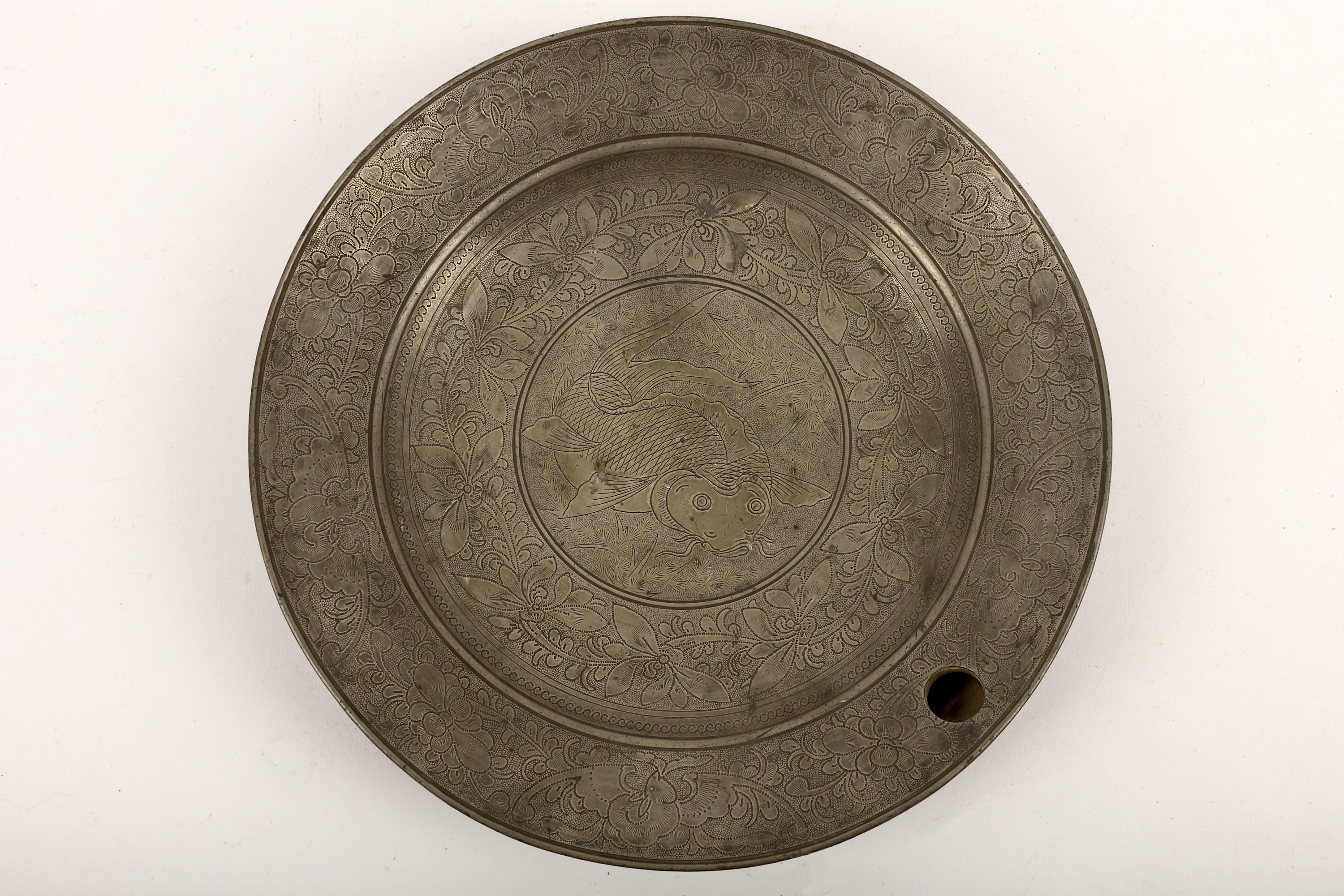A Chinese pewter dish warmer, of everted shape with a sealed base and a round hole in the dish for