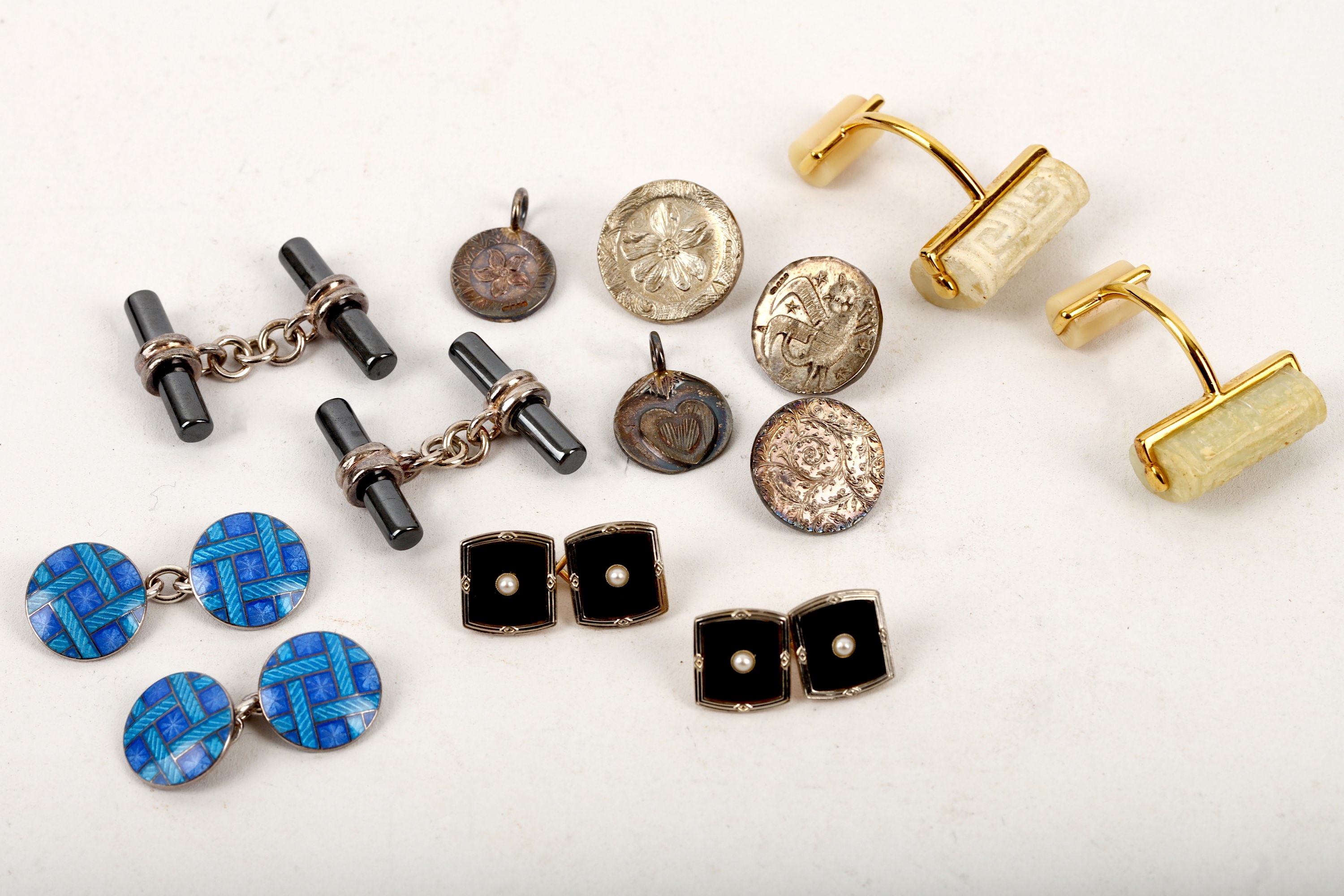 A small collection of jewellery, including a pair of silver and enamel cufflinks by Deakin &