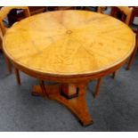 A Biedermeier maple breakfast table, with a segmented veneered top on hexagonal pillar and