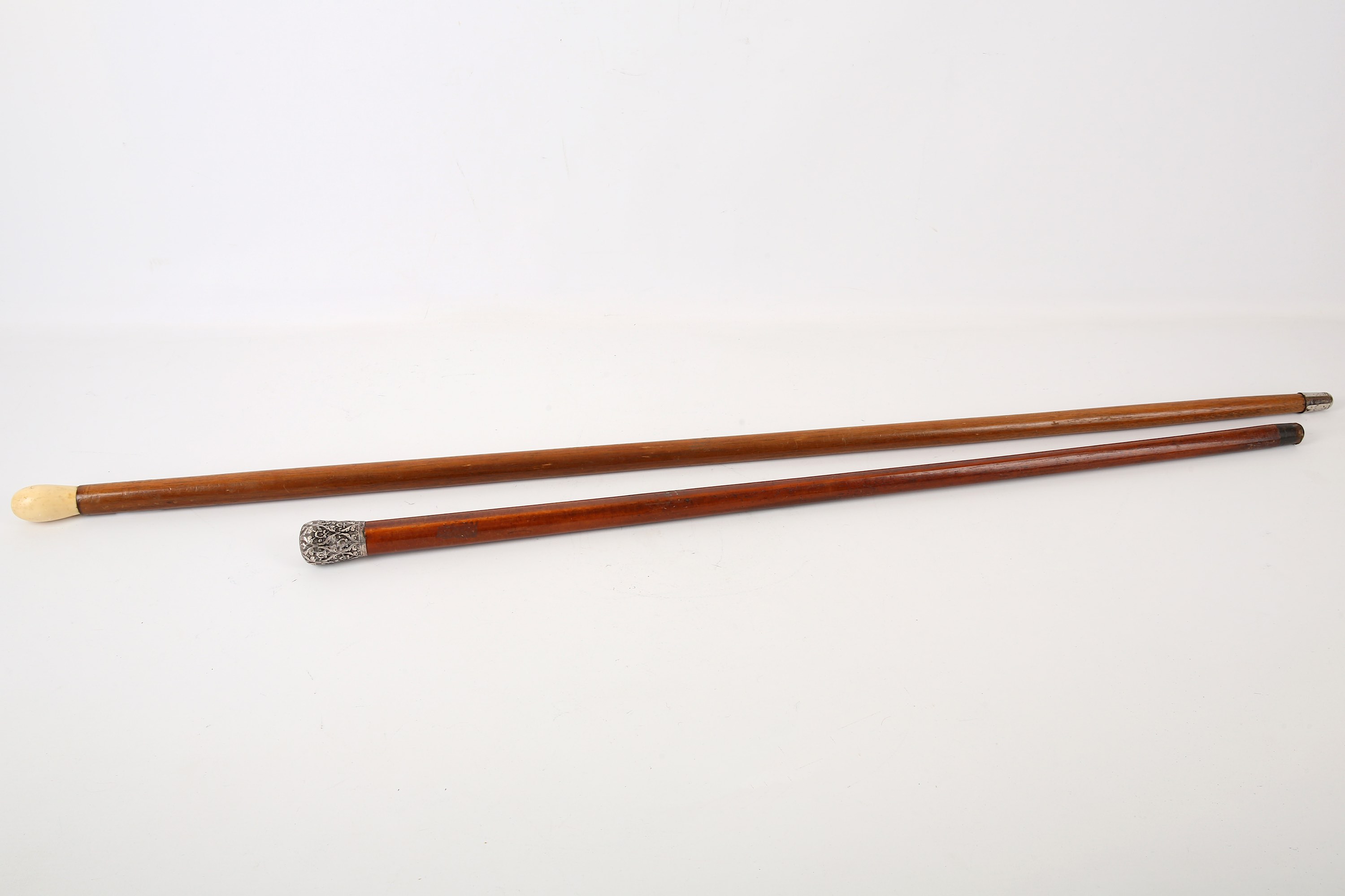 A Indian white metal mounted walking cane, late 19th / early 20th Century, and an early 20th century