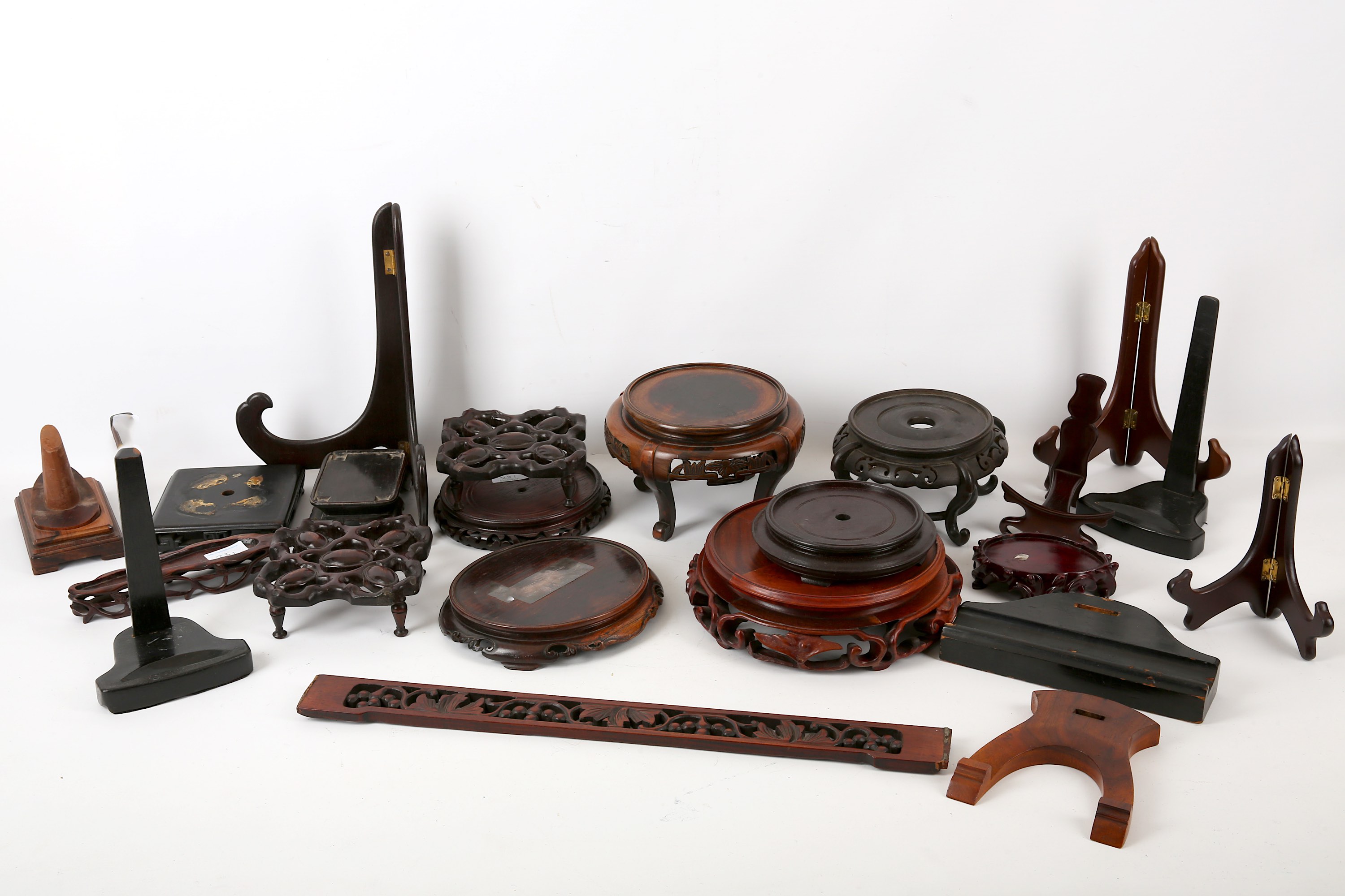 A collection of Chinese carved hardwood vase and other stands, together with assorted plate