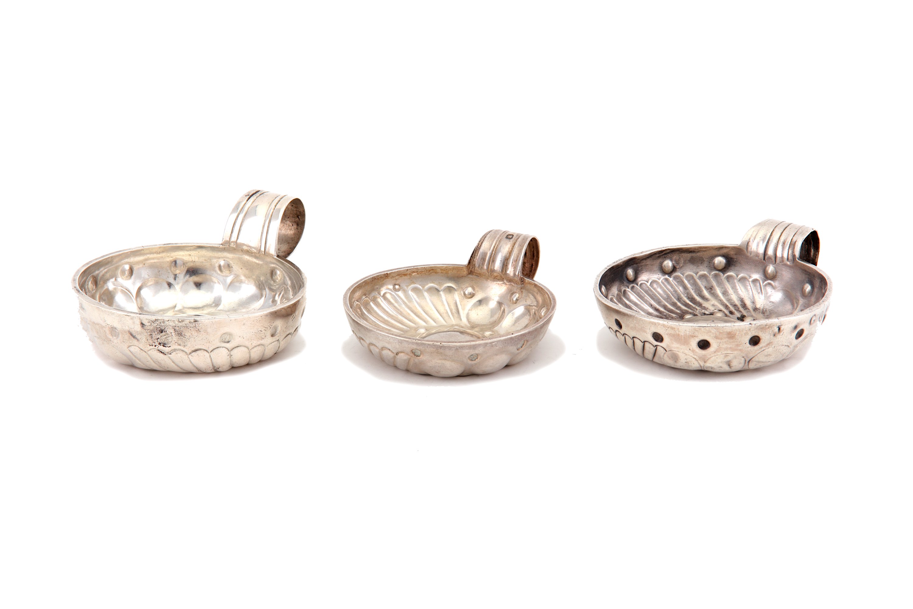 A mixed group of three 19th century French silver wine tasters, including a Paris example, 1819-38,