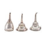 A mixed group of three antique sterling silver wine funnels, including a George IV example, London 1