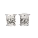 A pair of Edwardian silver bottle holders/coasters, London 1906, by William Comyns