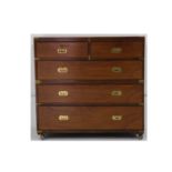 An early 20th Century brass mounted mahogany two-part military chest, fitted with two short and