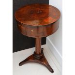 A early 19th Century Continental walnut work table, with a circular hinged top on a pillar and